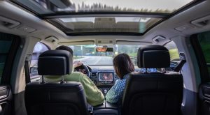 Man and woman traveling in car, sitting in car driving to travel destination.
